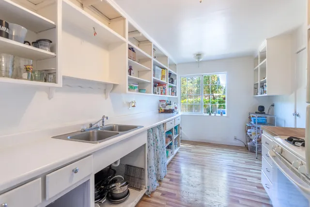 a kitchen that has a sink and a stove