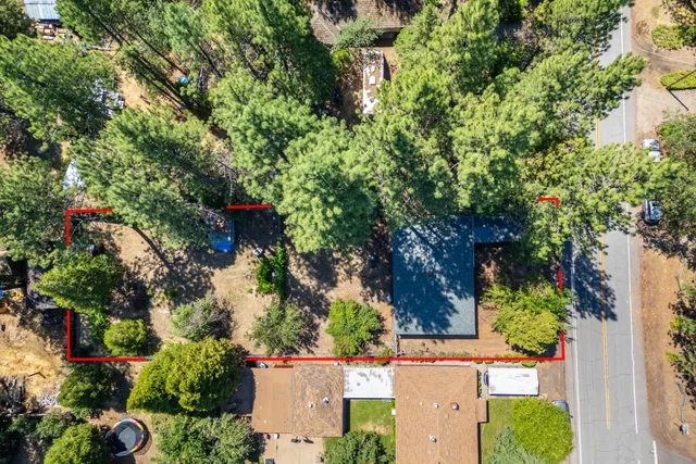 an aerial view of a house with a yard