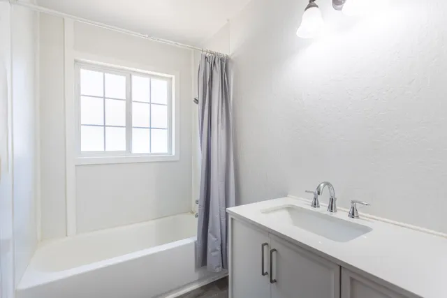 a white bath tub sitting next to a white sink