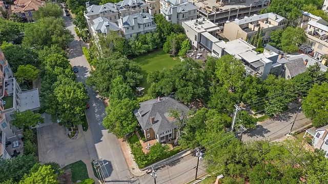 an aerial view of a house with a yard and outdoor seating