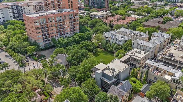 an aerial view of multiple houses with yard