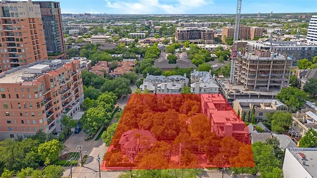 an aerial view of residential houses with city view