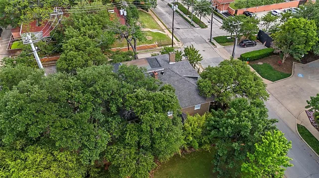 an aerial view of residential house with outdoor space and trees all around