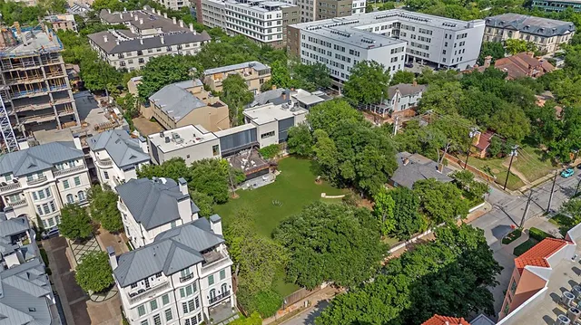 an aerial view of a building with garden space and street view