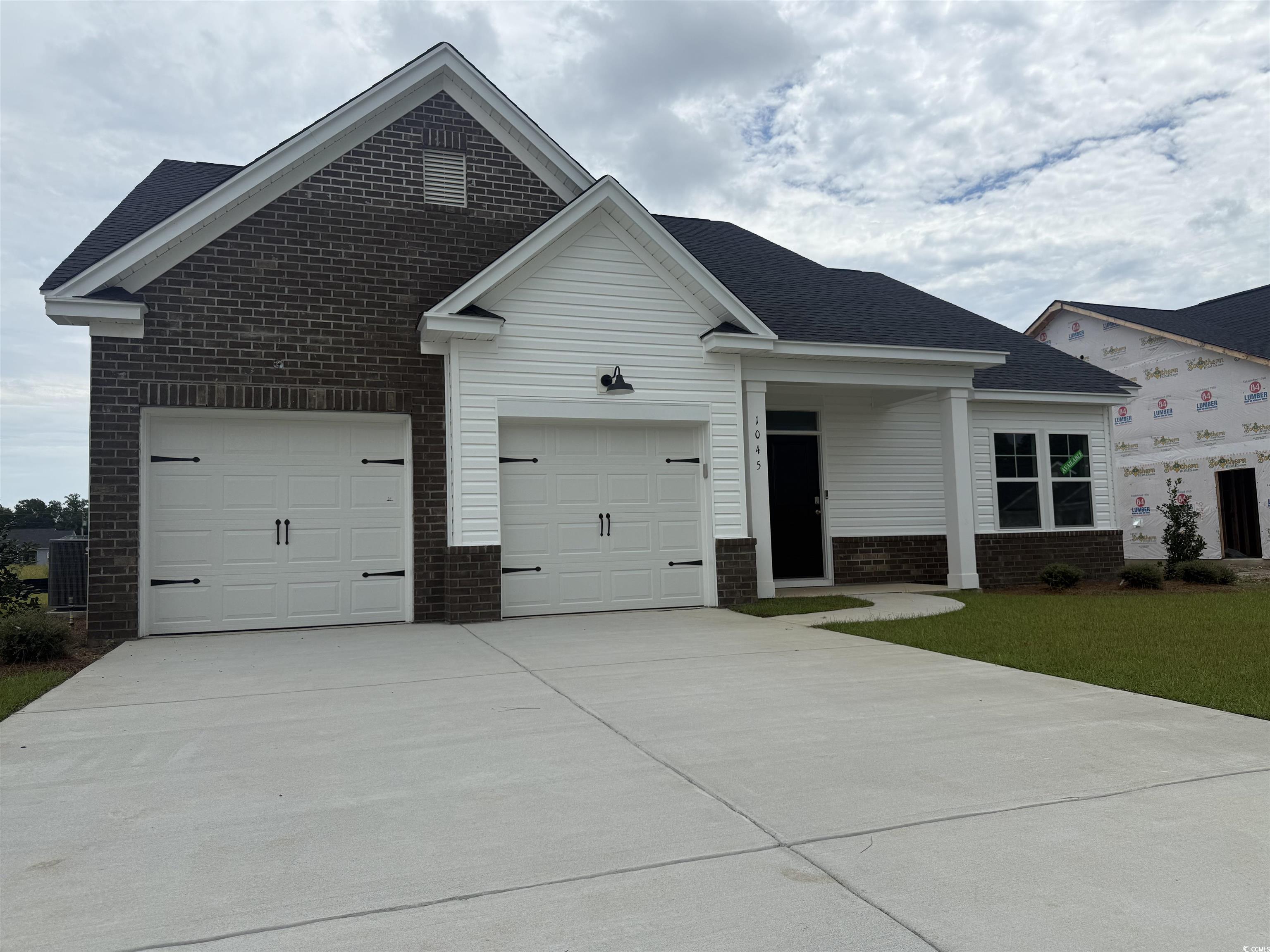 1045 Jase Drive Longs, SC 29568 - Photo 1 of 33 Single story home with brick siding, concrete driveway, and an attached garage