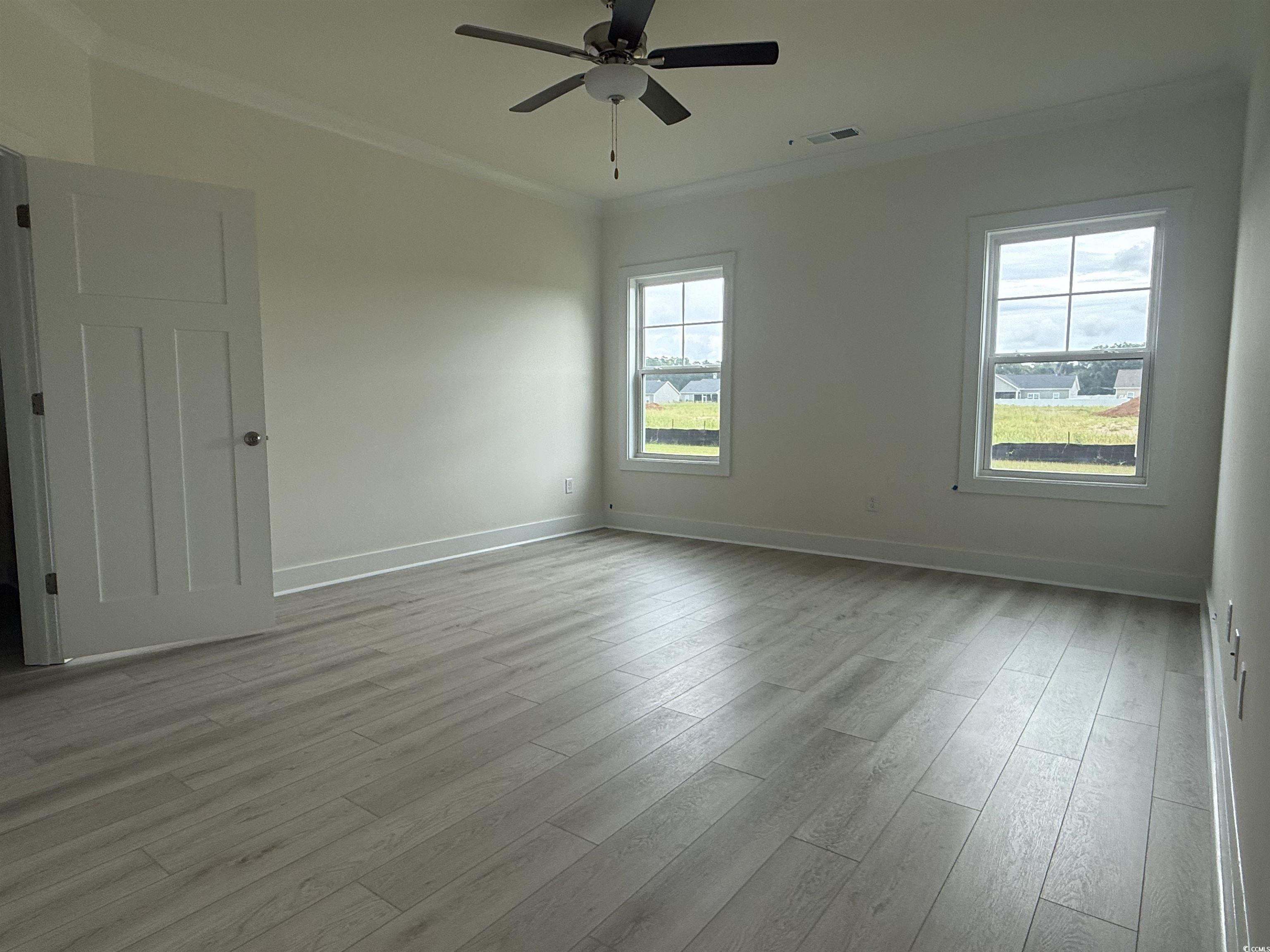 1045 Jase Drive Longs, SC 29568 - Photo 14 of 33 Unfurnished room featuring ornamental molding, light wood finished floors, and a ceiling fan