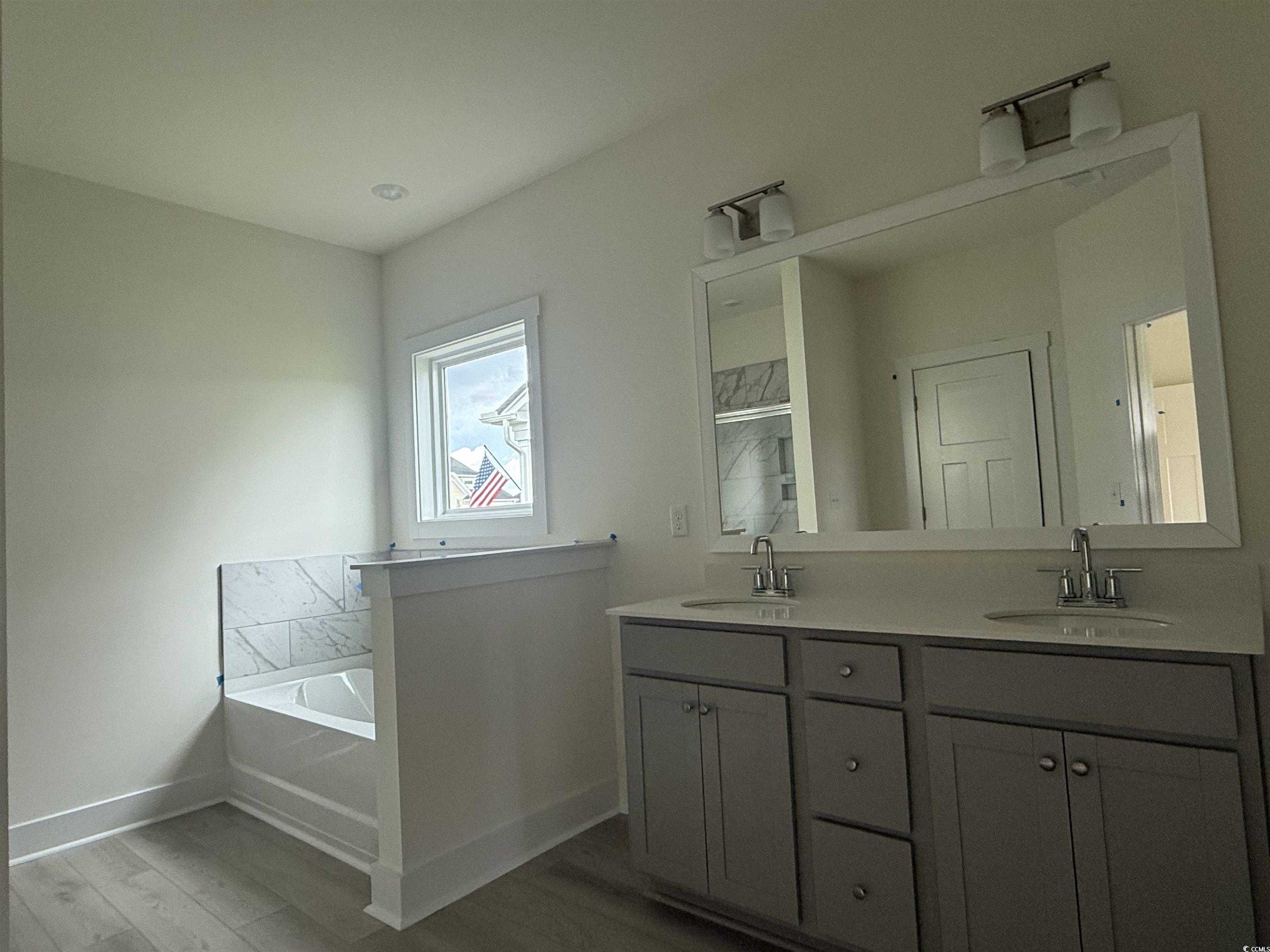 1045 Jase Drive Longs, SC 29568 - Photo 15 of 33 Full bath with a bath, double vanity, and wood finished floors