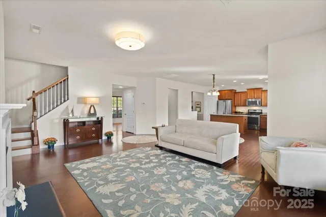 a living room with furniture and a dining table