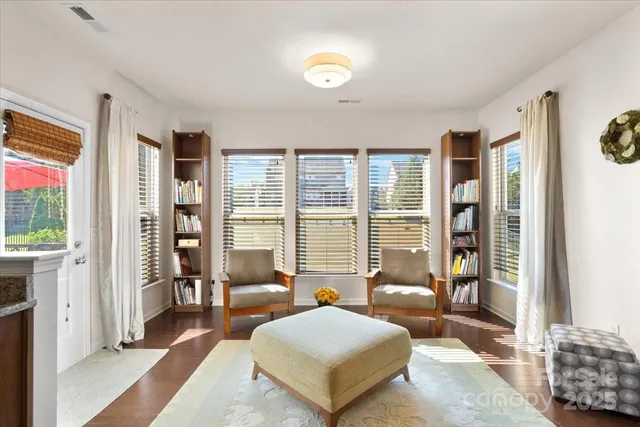 a spacious bedroom with a bed and glass window
