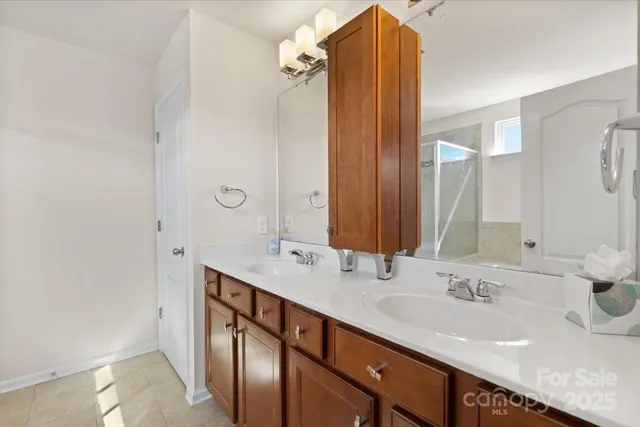 a bathroom with a double vanity sink and a mirror