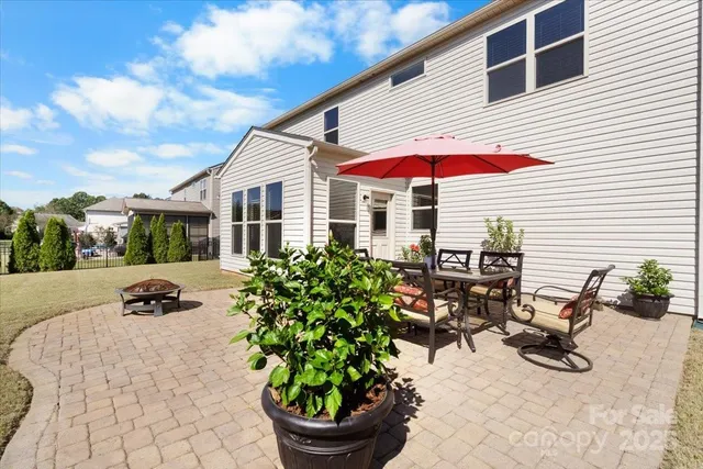 a view of a house with yard and sitting area