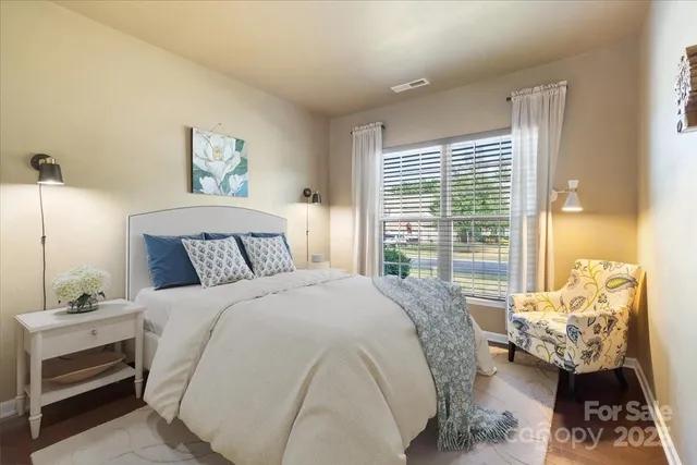 a bedroom with bed and a window