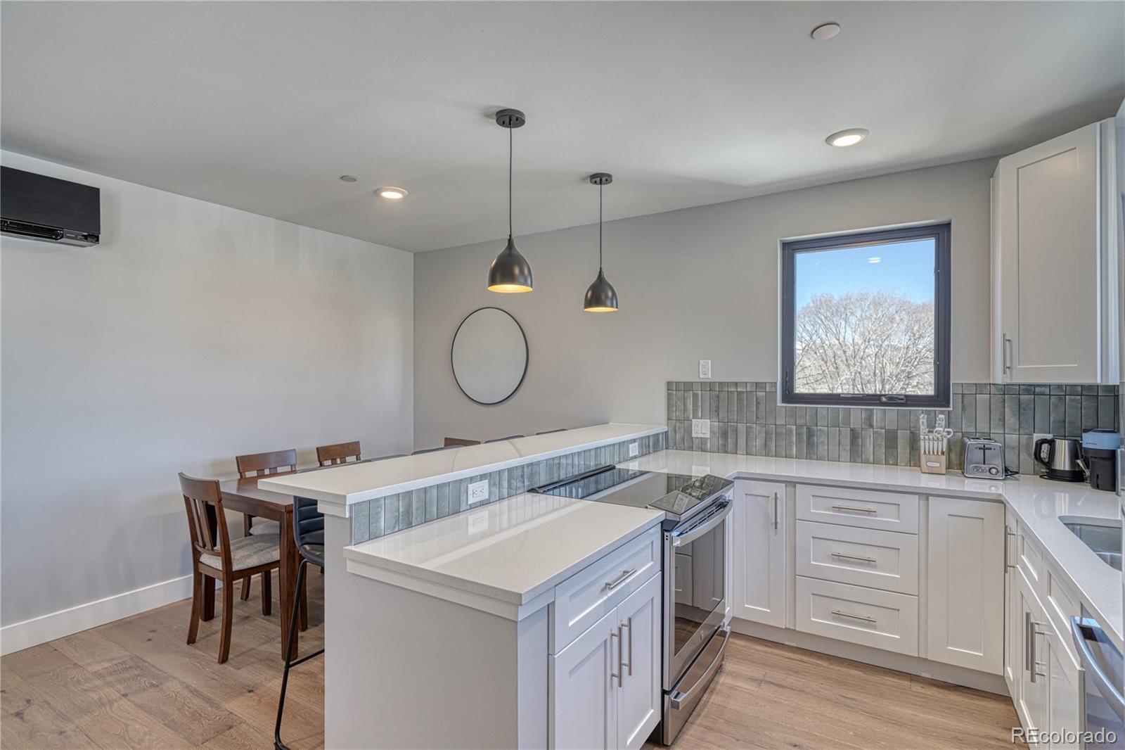 136 Old Stage Road, Unit 1E Salida, CO 81201 - Photo 12 of 26 a kitchen with a sink a stove cabinets and wooden floor