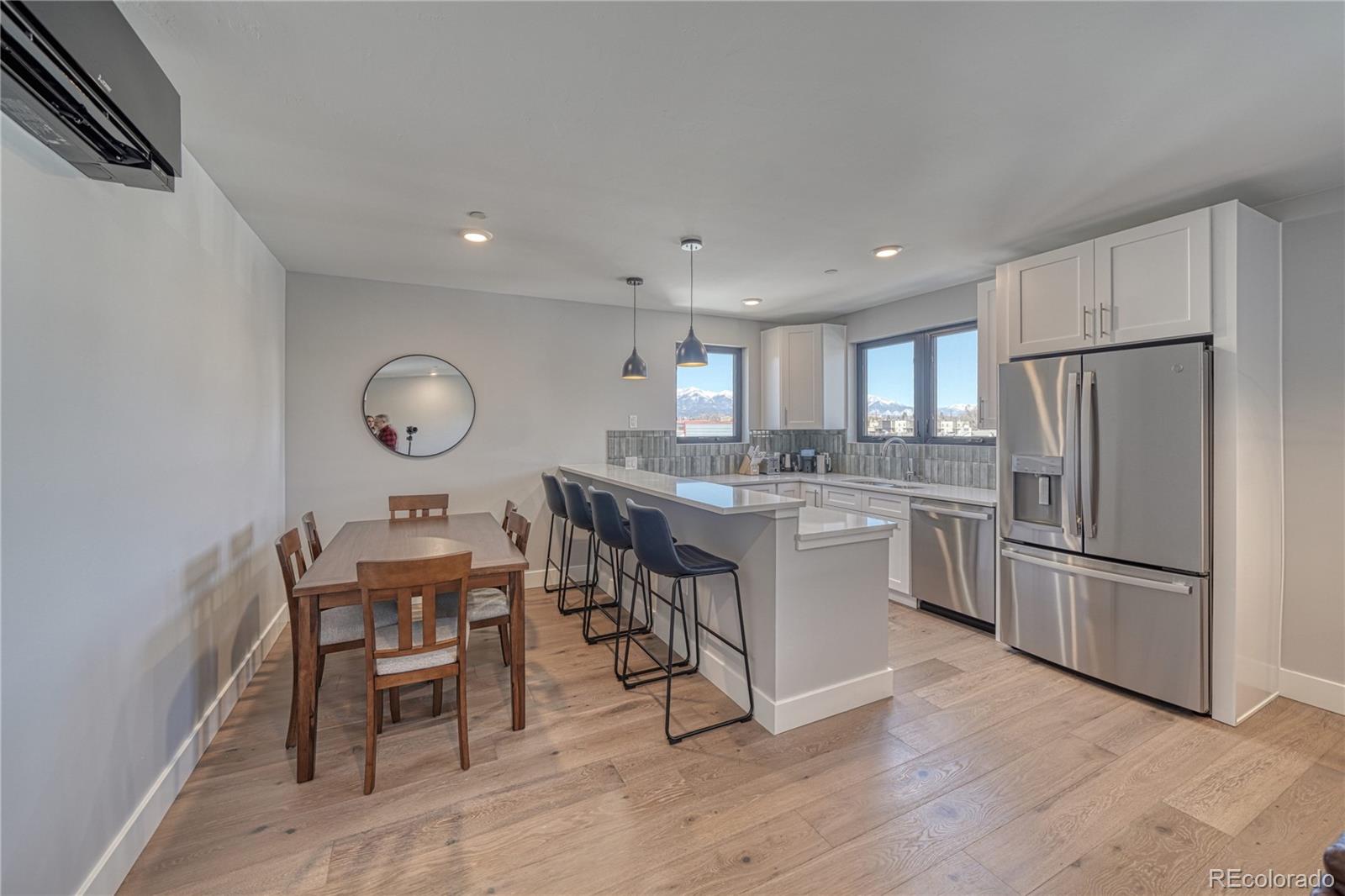 136 Old Stage Road, Unit 1E Salida, CO 81201 - Photo 15 of 26 a kitchen with a refrigerator a microwave oven a sink and chairs