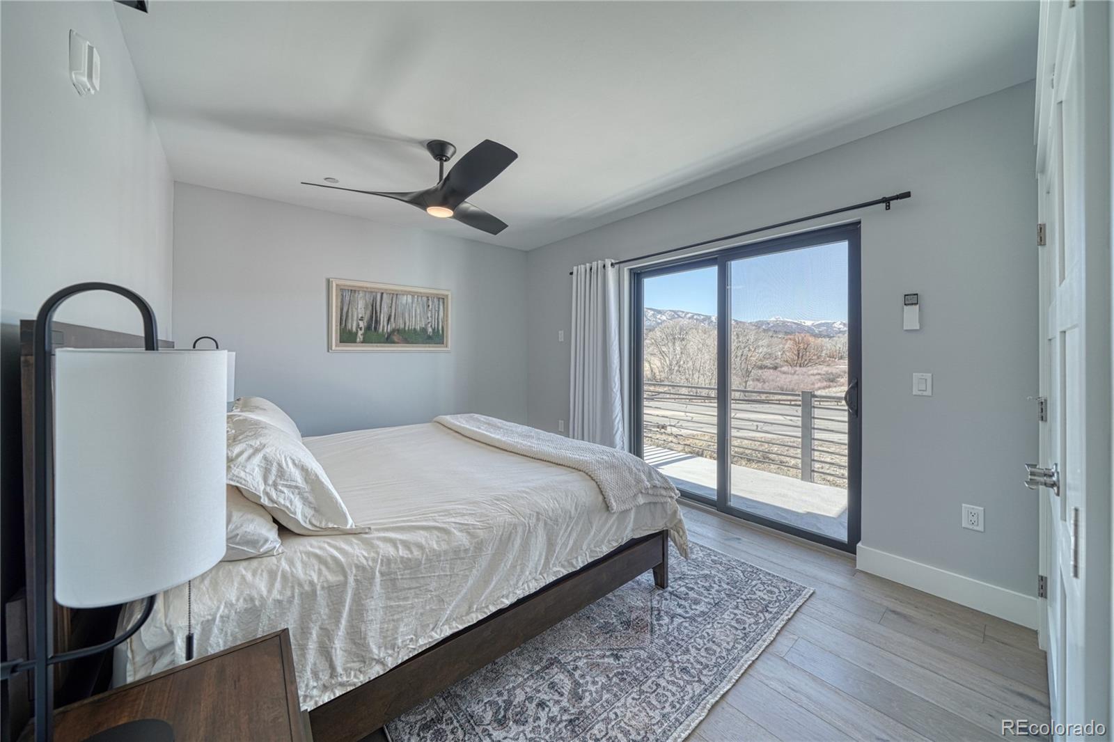 136 Old Stage Road, Unit 1E Salida, CO 81201 - Photo 19 of 26 a bed sitting in a bedroom next to a window