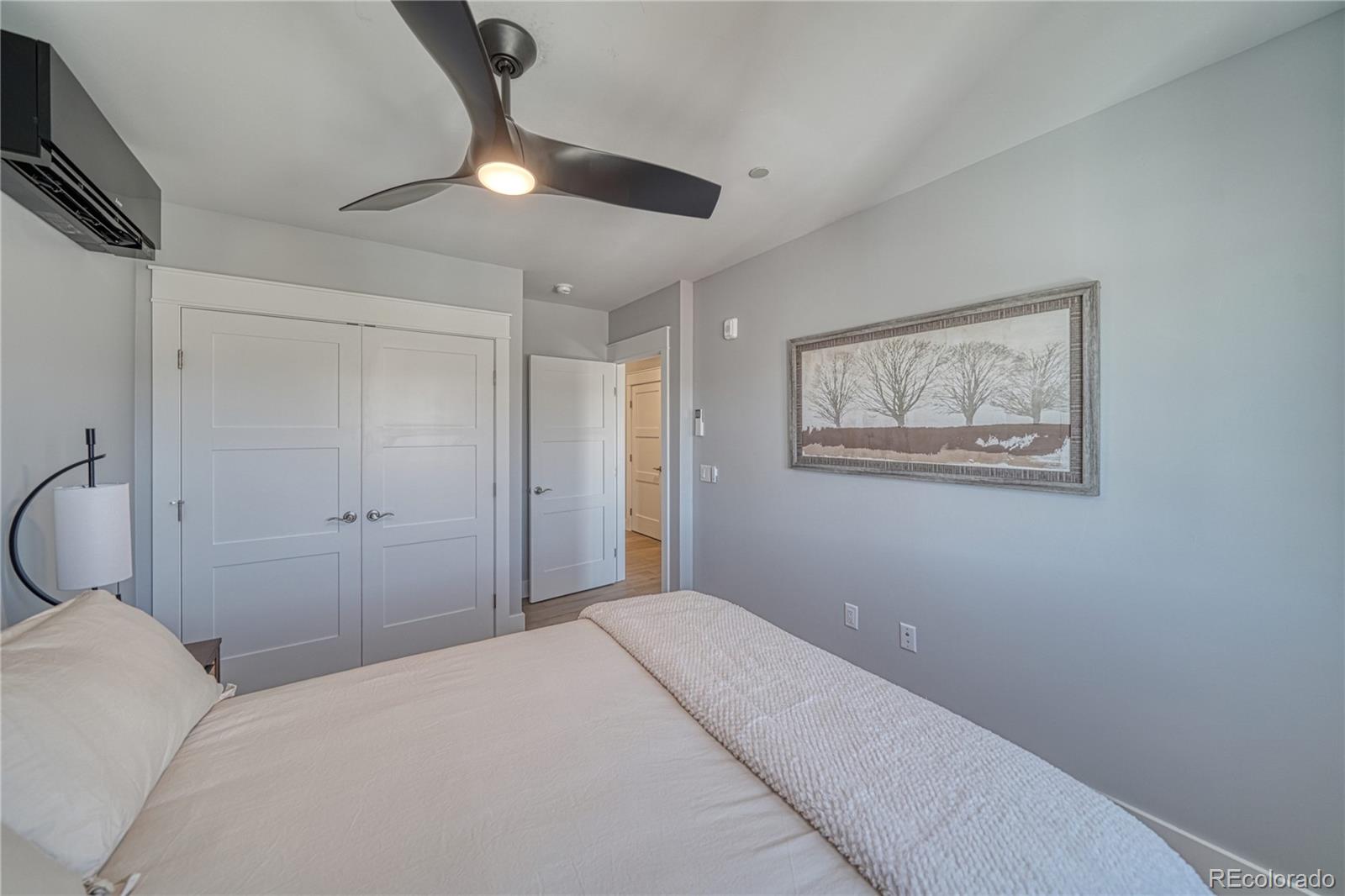 136 Old Stage Road, Unit 1E Salida, CO 81201 - Photo 20 of 26 a bedroom with a bed and a chandelier