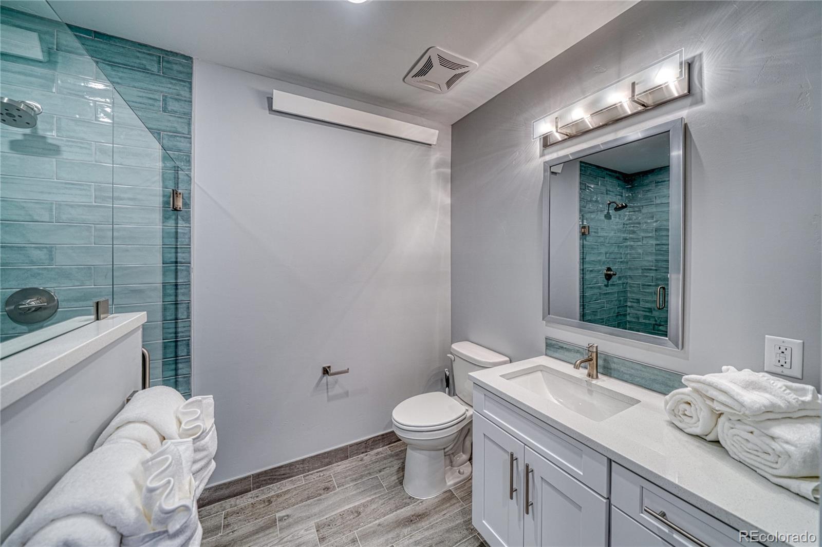 136 Old Stage Road, Unit 1E Salida, CO 81201 - Photo 22 of 26 a bathroom with a granite countertop sink toilet and shower