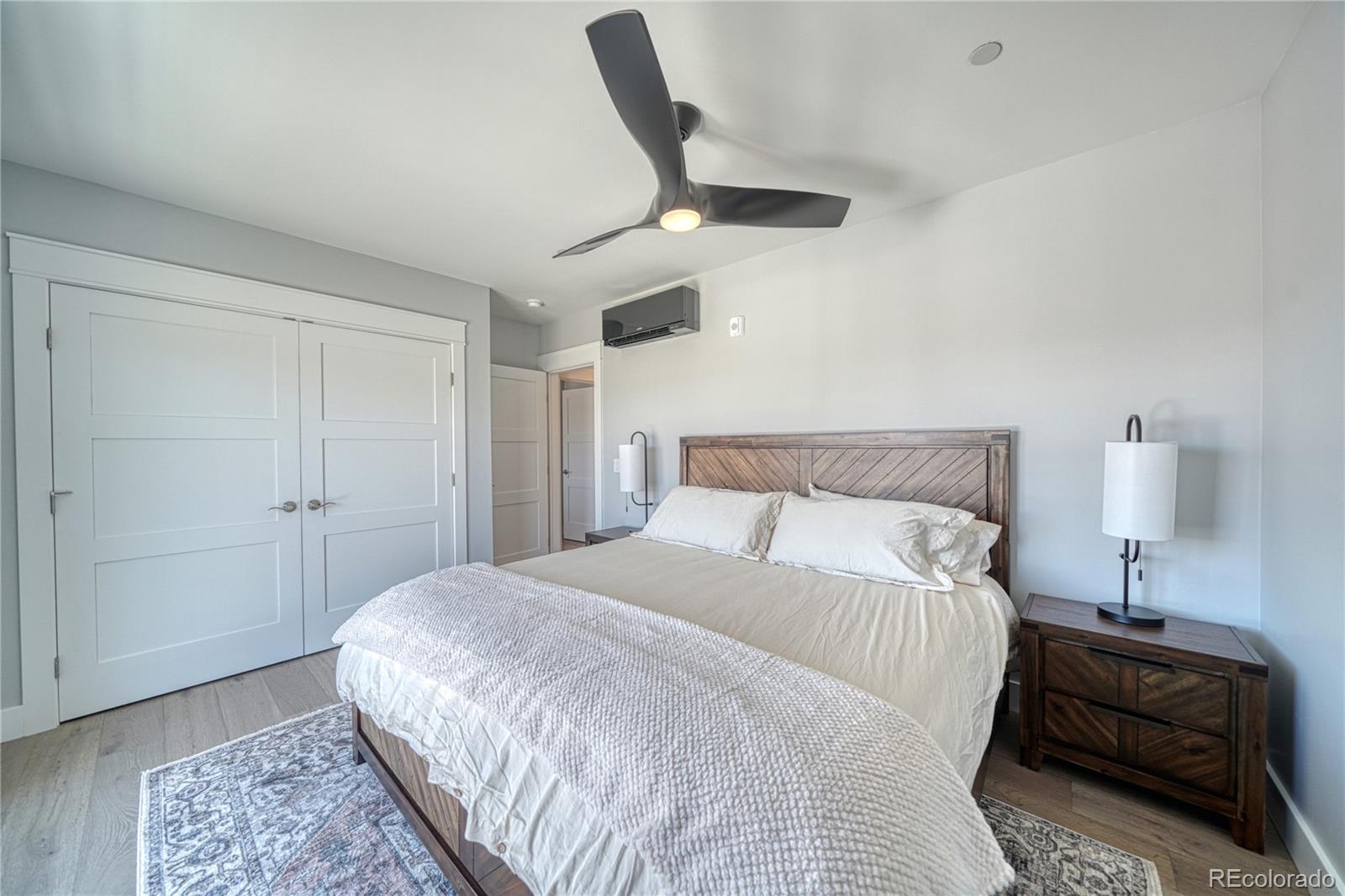 136 Old Stage Road, Unit 1E Salida, CO 81201 - Photo 24 of 26 a bedroom with a bed and a lamp on the dresser