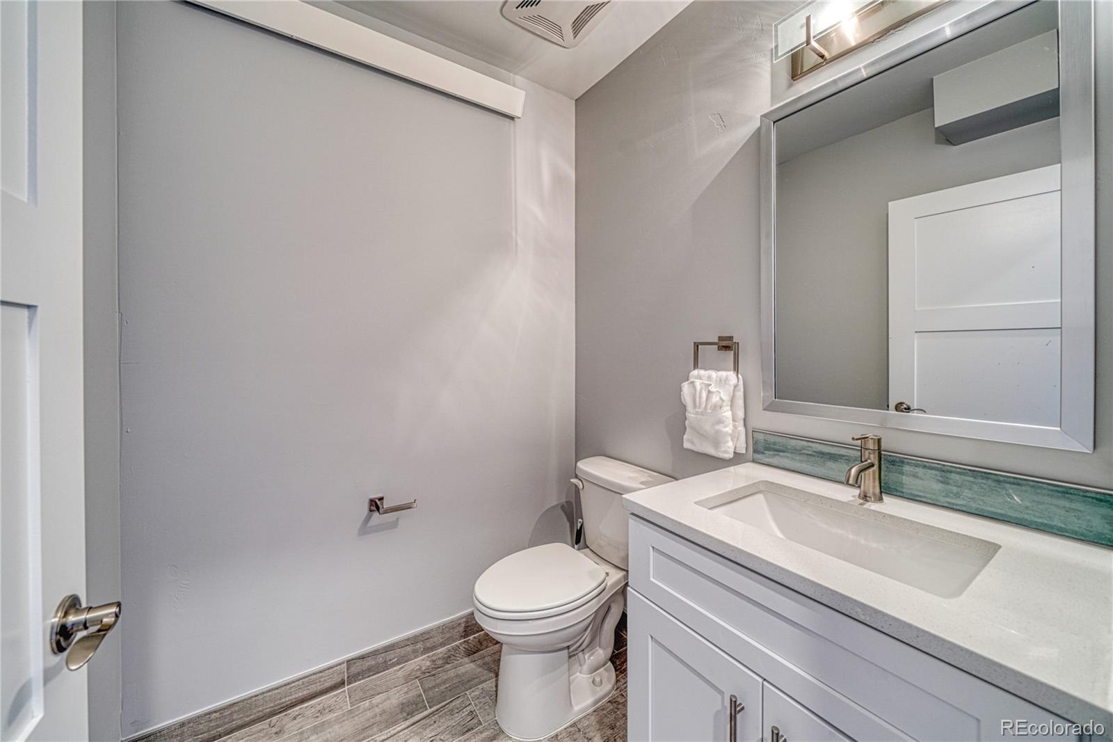 136 Old Stage Road, Unit 1E Salida, CO 81201 - Photo 25 of 26 a bathroom with a sink a toilet and vanity