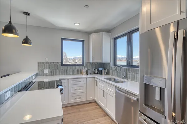 a kitchen with white cabinets and stainless steel appliances