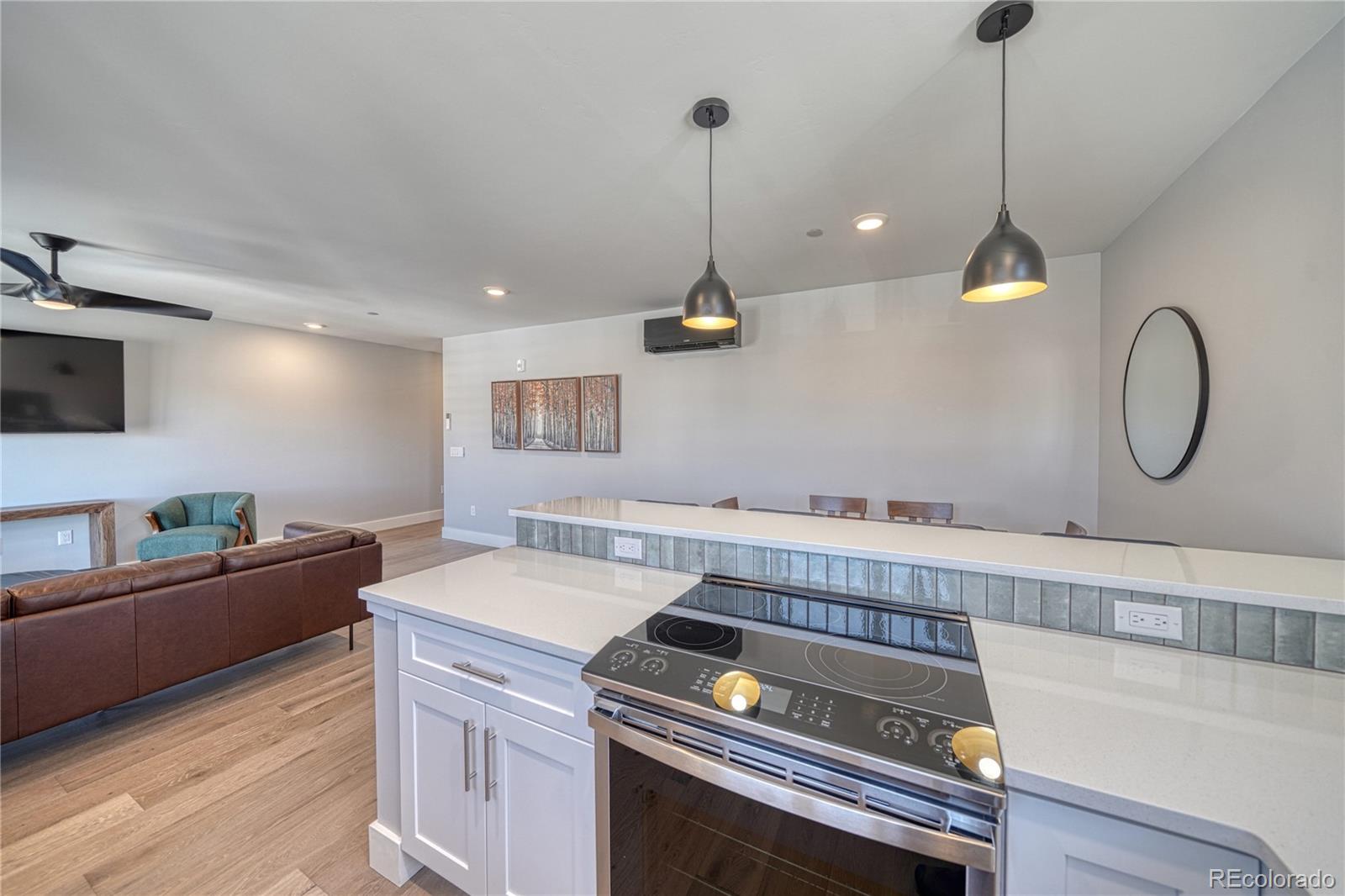 136 Old Stage Road, Unit 1E Salida, CO 81201 - Photo 9 of 26 a kitchen with a stove and a wooden floor