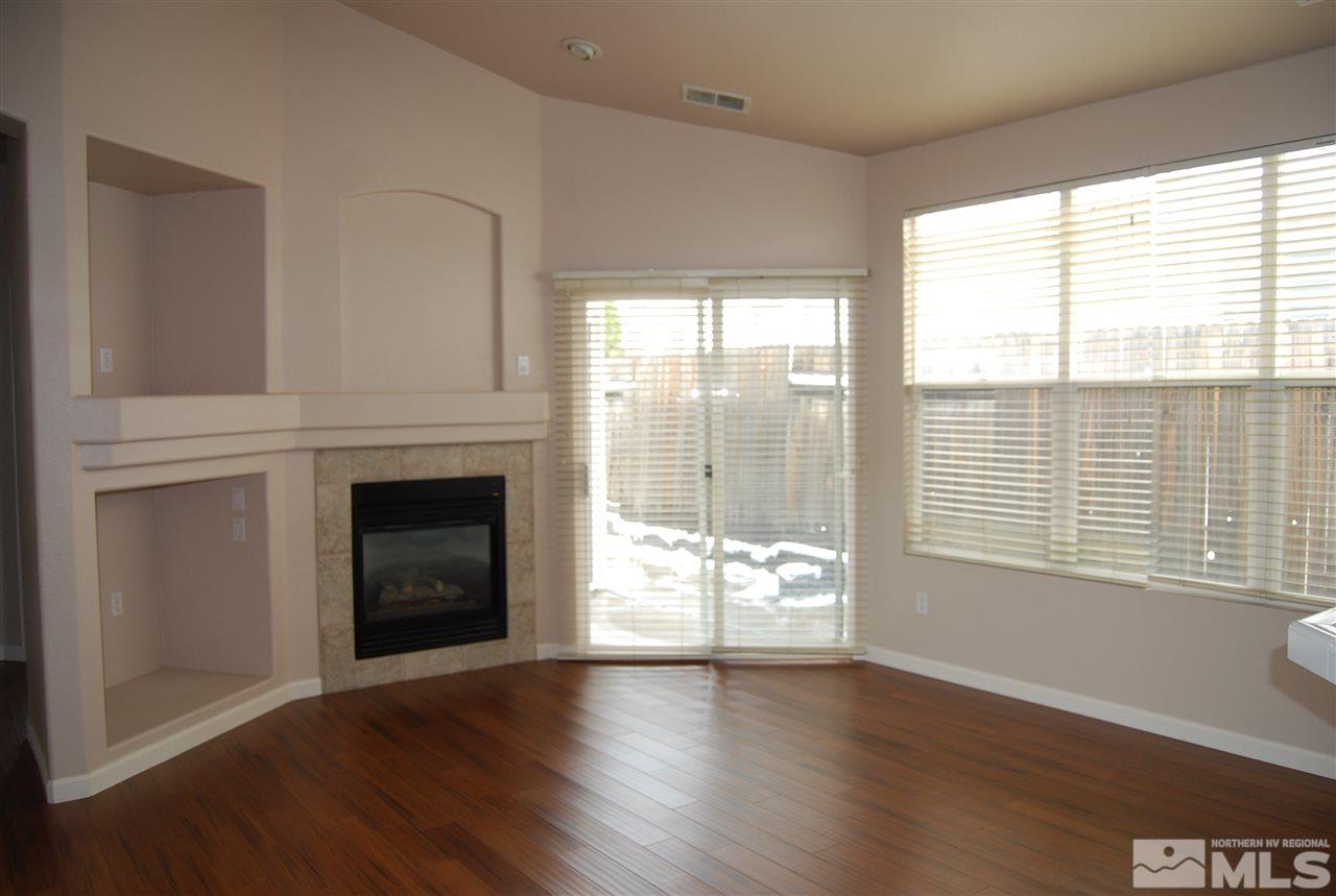 1249 Tule Drive Reno, NV 89521 - Photo 6 of 12 a view of a livingroom with a fireplace and window