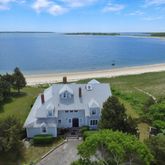 an aerial view of a house with a garden and lake view