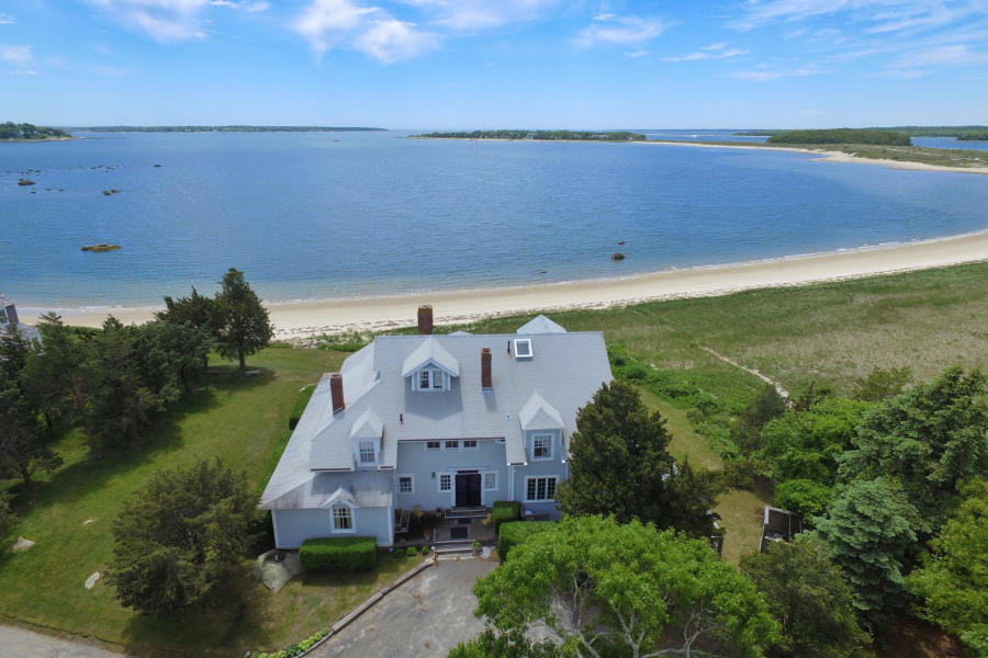 an aerial view of a house with a garden and lake view