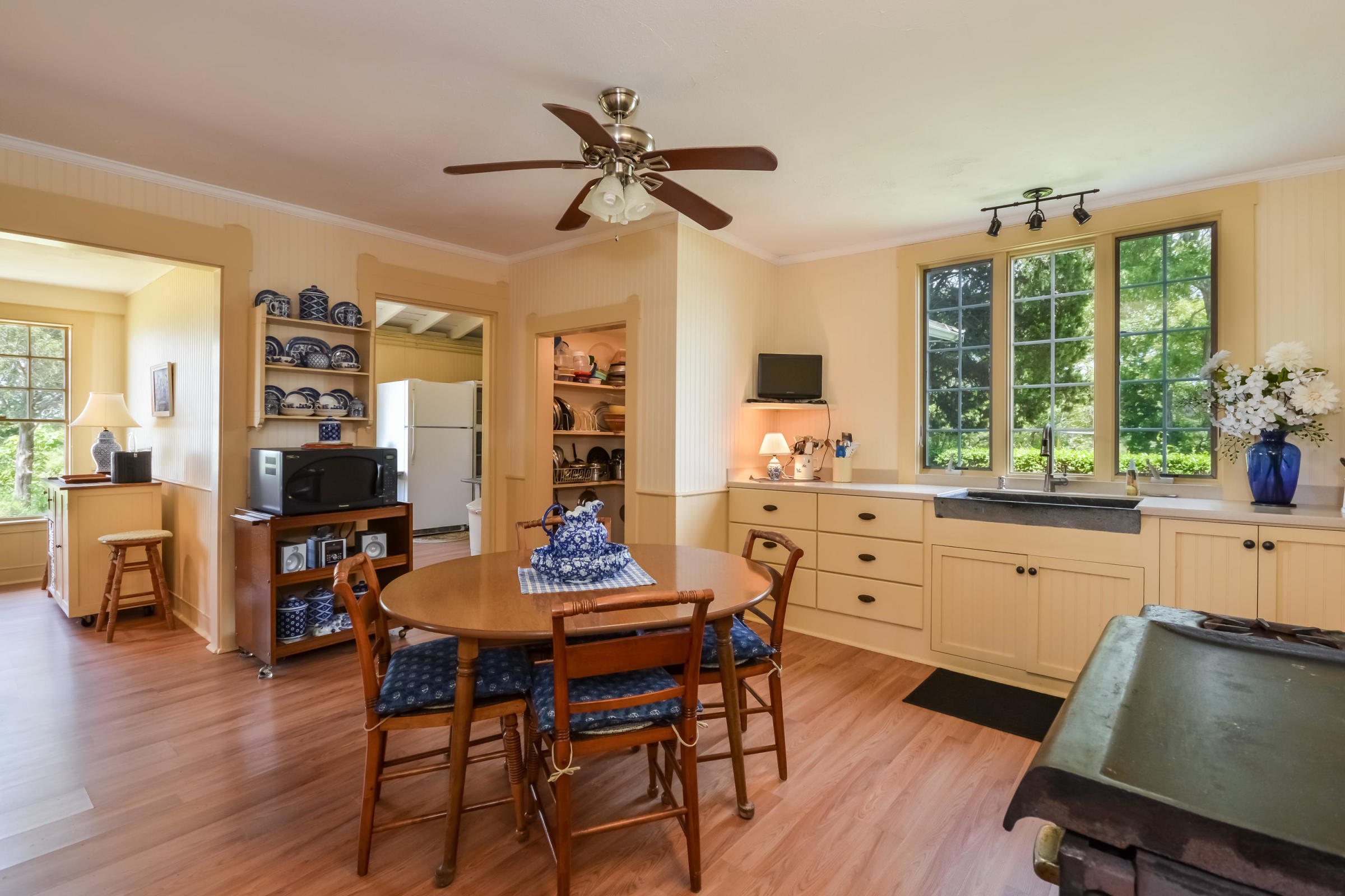 96 Rocky Point Road Bourne, MA 02532 - Photo 12 of 28 a kitchen with a table chairs stove and white cabinets