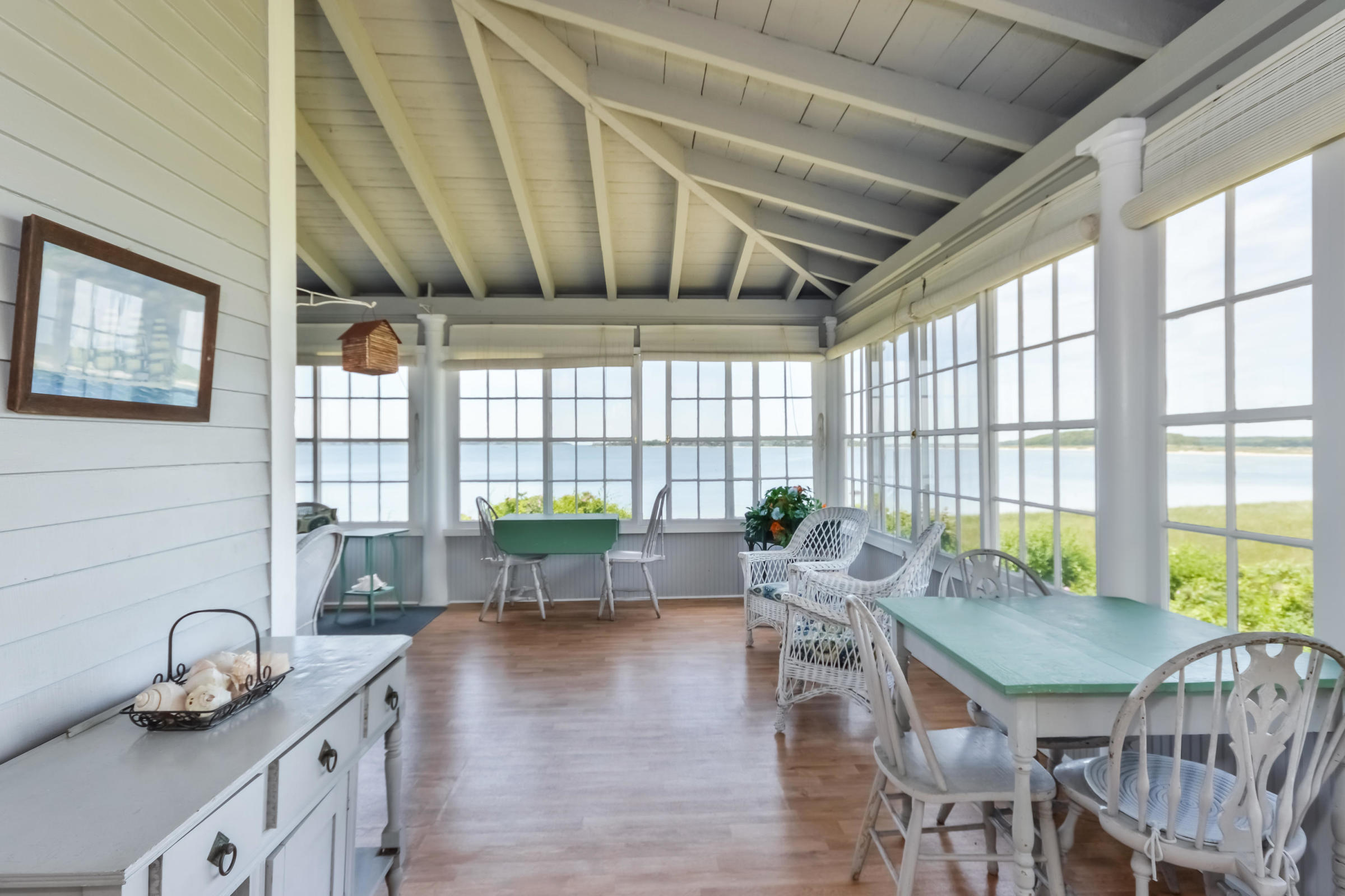96 Rocky Point Road Bourne, MA 02532 - Photo 18 of 28 a dining room with furniture a chandelier and wooden floor
