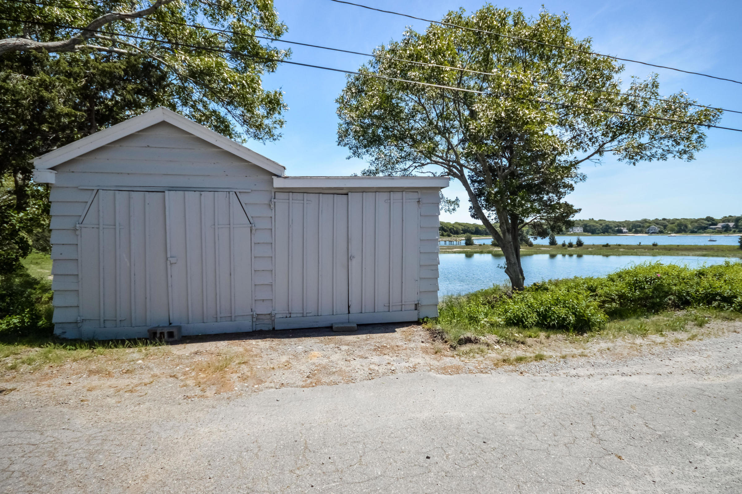 96 Rocky Point Road Bourne, MA 02532 - Photo 25 of 28 a house view with a garden