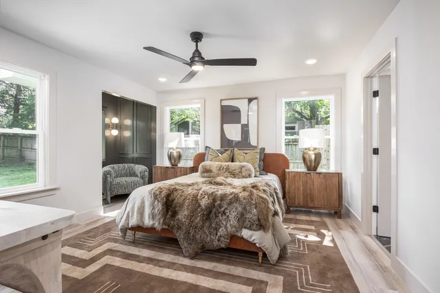 a bedroom with a bed and a mirror