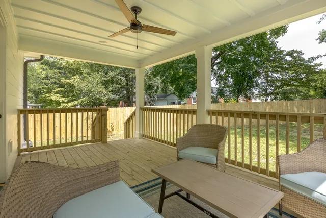 a view of a chair and table on the wooden deck