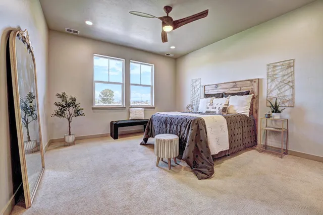 a spacious bedroom with a bed and a chandelier