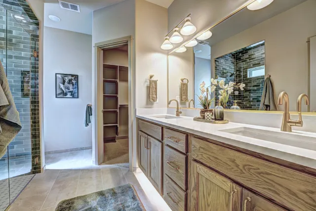 a spacious bathroom with a double vanity sink and a mirror