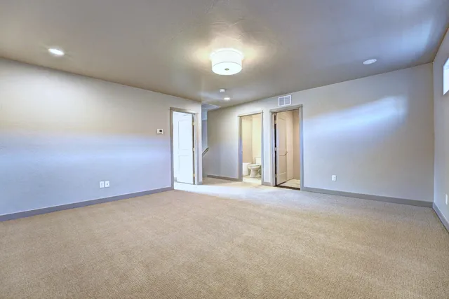 an empty room with windows and closet