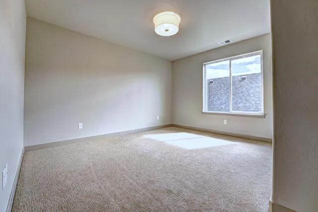an empty room with windows and closet