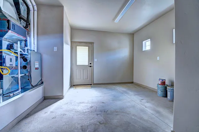 a view of an empty room with a window and storage