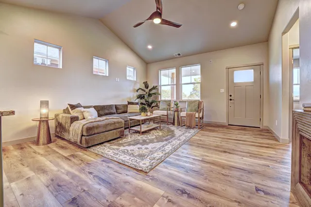 a living room with furniture and a wooden floor