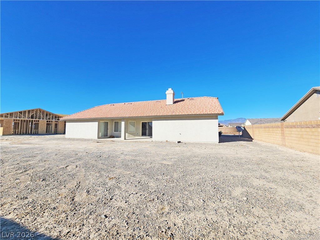 4591 Stoneham Street Pahrump, NV 89061 - Photo 40 of 42 A newly constructed residence offers a blank canvas for future landscaping, with a durable tile roof and an open patio space.