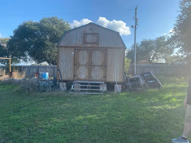 a view of a backyard with swimming pool