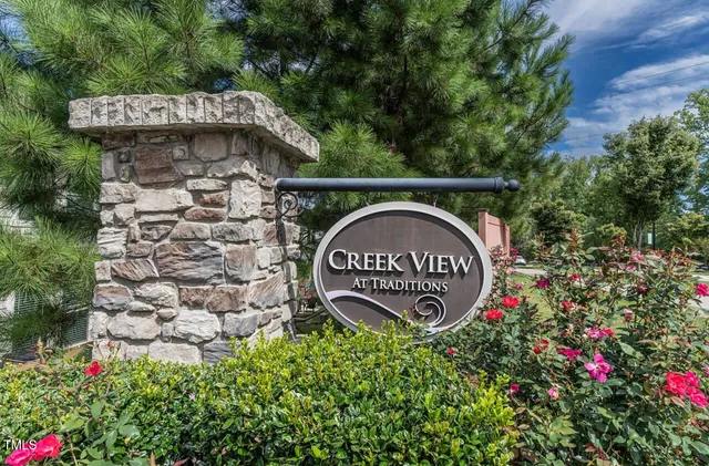 a sign that is sitting in front of flowers