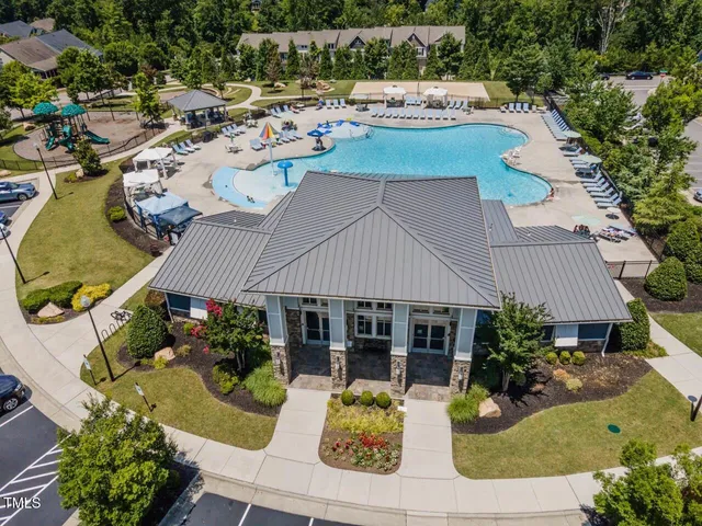 an aerial view of a house with swimming pool patio and outdoor seating