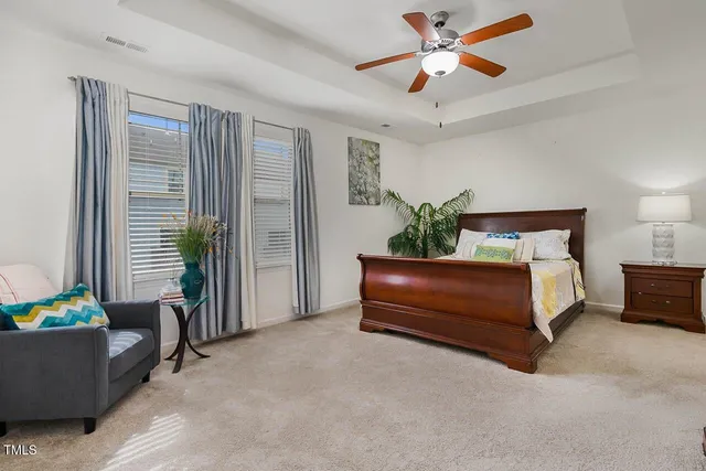 a bedroom with furniture and a potted plant