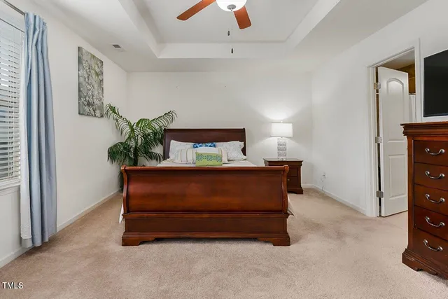 a room with a bed and a potted plant