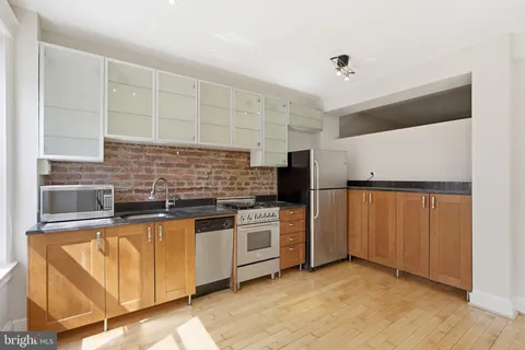 a kitchen with stainless steel appliances a stove sink and cabinets
