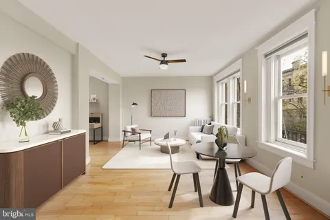 a living room with furniture a table and a large window