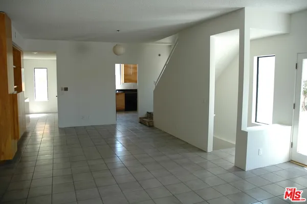 a view of a hallway view with wooden floor and staircase