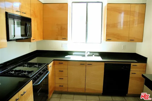 a kitchen with a stove and a sink
