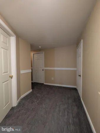 an empty room with windows and fireplace